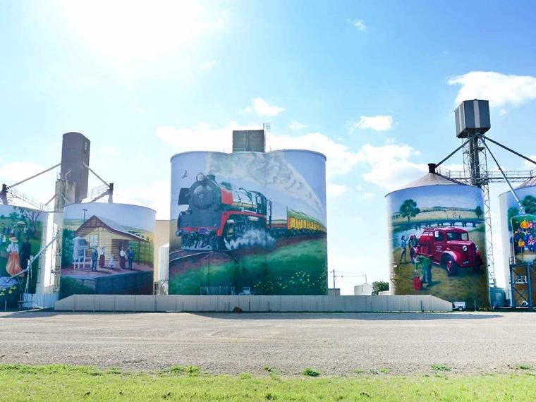 large silos covered in murals