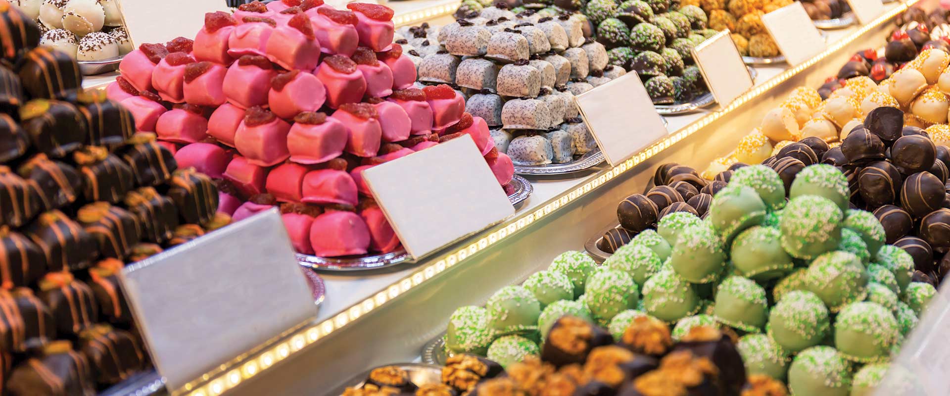 Piles of different coloured sweets in display in a market, Hungary